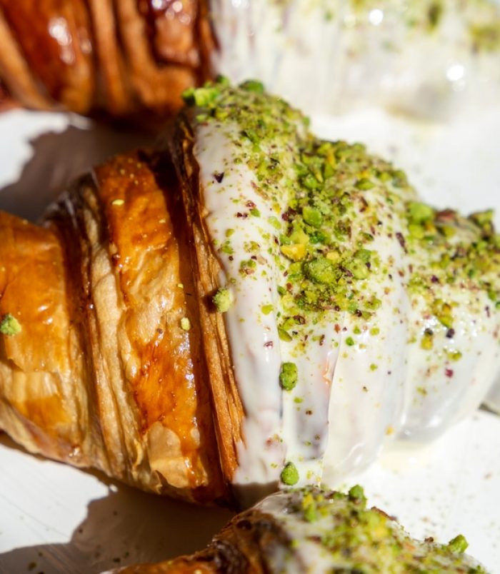 Pistachio-flavored,Croissants,Half,Covered,In,White,Chocolate.,Beautifully,Decorated,Croissants